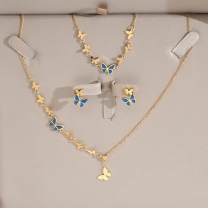Three-piece gold and blue butterfly jewelry set including necklace, bracelet, and earrings