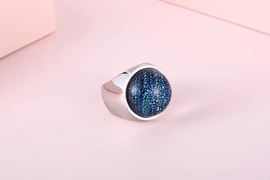 Top view of silver stainless steel ring featuring a round blue marbled resin stone