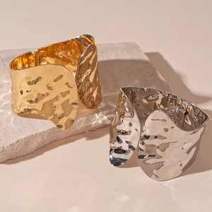 Metallic wide open bangle with hammered texture in gold and silver finishes