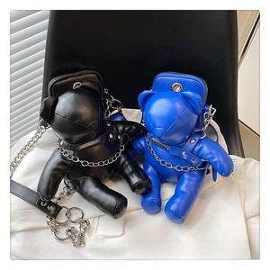 Close-up of punk style bear crossbody bags in black and blue PU leather with chains
