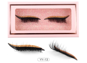Macro view of YY-13 false eyelashes with gold glitter eyeliner stickers in pink box
