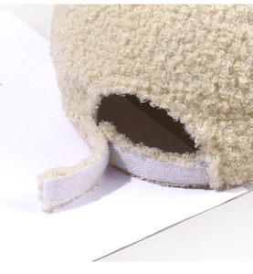 Detail of adjustable velcro strap on cream teddy fleece baseball cap with soft texture