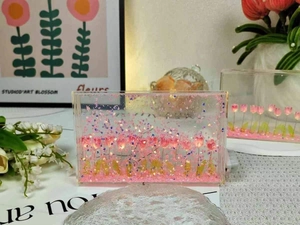 Detailed view of pink tulips and sparkling glitter inside transparent acrylic night light