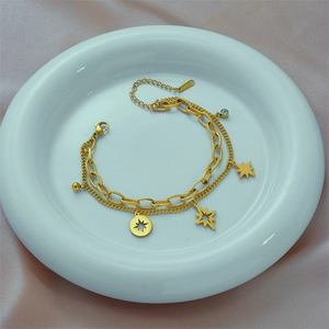 Double-layered gold titanium steel bracelet featuring star charms and Cuban link chain