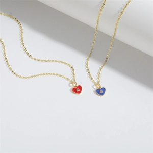 French vintage gold necklace with red and blue heart pendants and center crystals