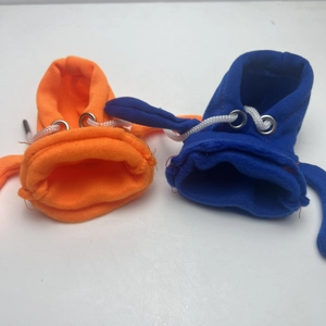 Detail view of miniature cotton hoodie covers for car gear shifts in blue and orange colors