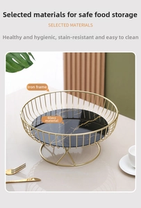 Detail of Nordic gold iron frame fruit tray with black marble pattern glass base