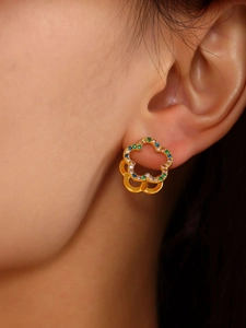 Macro detail of double-layer flower earrings with colorful zircons and 18K gold plating
