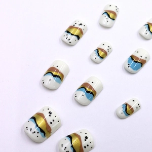 Short elegant press-on nails set with abstract blue and gold artistic patterns