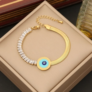 Gold double-layer evil eye bracelet with clear zircon and snake chain in jewelry box
