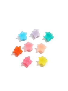 Macro detail of eight colorful jelly star hair clips in vibrant macaron shades