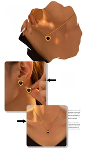 Detail of vintage black heart necklace and stud earrings set on a model