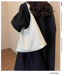 Detail of high-quality white lychee grain leather tote bag with soft texture and spacious design