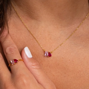 Close-up of S925 silver set with pink rectangular and red pear-shaped gemstones