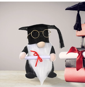 Close-up of graduation gnome with black gown, golden glasses and diploma scroll