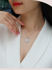 Elegant model wearing a S925 silver round halo moissanite pendant necklace for women