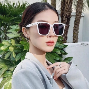 Side view of model wearing white marble square sunglasses with dark purple lenses