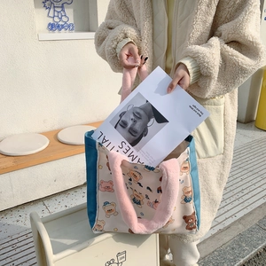 Detail of canvas tote bag showing plush pink handles and cute cartoon bear print