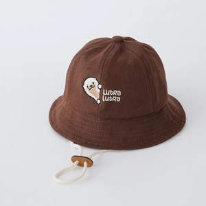 Detail showing deep brown cotton baby bucket hat with otter embroidery and adjustable strap