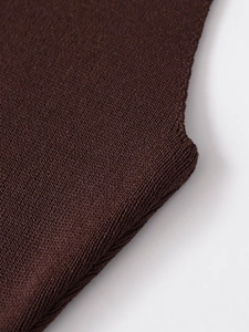 Close-up of fine knit texture and high-quality flat stitch on a dark brown sweater