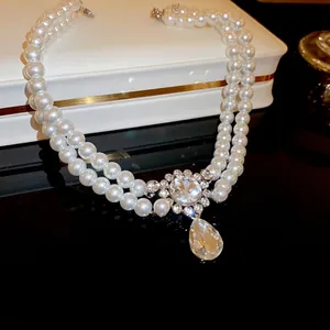Elegant double-layer pearl necklace with rhinestone flower and pear-shaped drop pendant