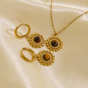 Detail of 14K gold plated sunburst necklace and earrings set with tiger eye stones