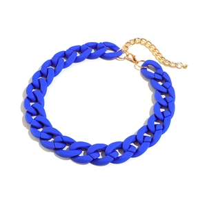 Macro detail of blue matte acrylic Cuban chain link necklace with gold metal lobster clasp