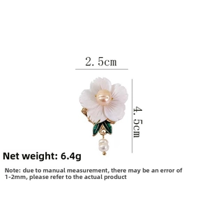 Detailed view of floral shell brooch with dimensions 2.5cm by 4.5cm and 6.4g weight