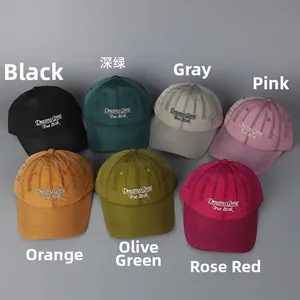 Flat lay of quick-dry baseball caps in seven colors with Dreams Come True embroidery