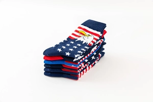 Close-up stack of cotton crew socks featuring US flag patterns and bald eagle designs