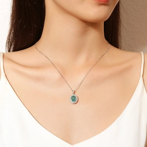 Elegant S925 silver necklace with green oval halo pendant worn by a female model
