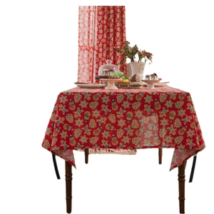 Red Christmas gingerbread man print cotton linen rectangular tablecloth on a wooden table