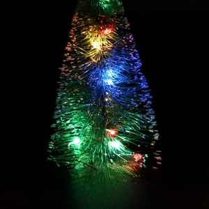 Glow macro view of a mini Christmas tree with colorful LED lights on black backdrop