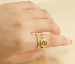 Detail of 18k gold plated stainless steel double-layered buckle ring on female finger