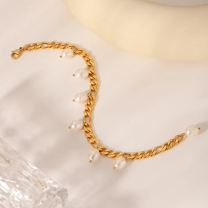 Close-up of gold plated stainless steel anklet with natural white freshwater pearls