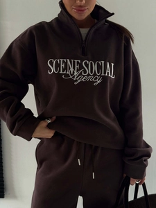 Detail of coffee brown sweatshirt set featuring white embroidery on cozy fleece fabric