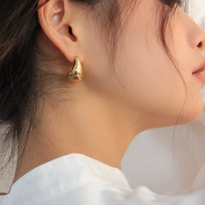 Polished gold teardrop earrings for women featuring a minimalist irregular metal design