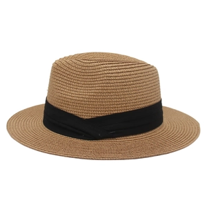 Detailed close-up of woven straw panama hat featuring a classic black fabric ribbon band