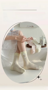 Detail of sweet bow ribbons on breathable mesh crew socks in pastel cream colors