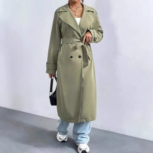 Detail of elegant olive green double-breasted trench coat with waist belt and lapels