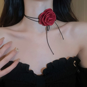 Close-up of handmade burgundy velvet rose choker on black thin string cord necklace