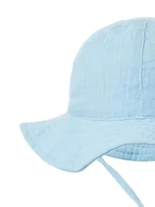 Close-up of light blue cotton baby sun hat with natural crinkle texture and chin straps