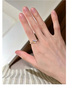 Detail shot of a s925 silver gold-plated ring with pearl floral and colorful gemstones