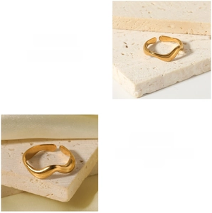 Detail of adjustable gold-plated wave ring with irregular textured finish on stone