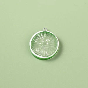 Macro detail of translucent green resin lemon slice pendant with realistic fruit texture