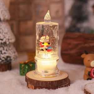 Close-up of Santa Claus LED water candle on wood base with festive holiday decor