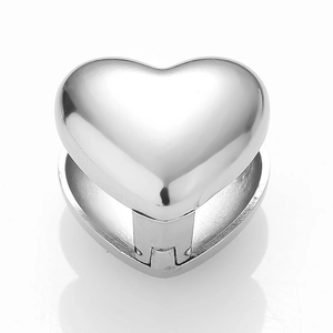 Macro view of a polished silver heart-shaped locket pendant with hinge detail