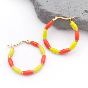 Detail view of gold-plated bamboo hoop earrings with yellow and orange enamel beads