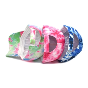 Colorful tie-dye baseball caps with adjustable velcro straps in green, pink, and blue tones