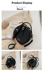 Detail of a round black leather crossbody bag with gold hardware and stylish accessories